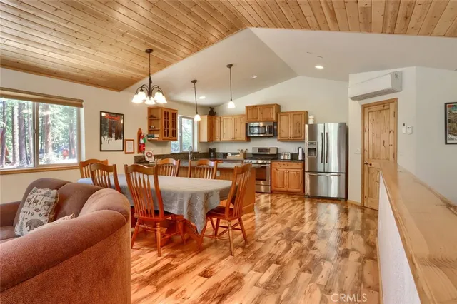 a large kitchen with granite countertop a stove a sink and dishwasher wooden cabinets with granite countertops