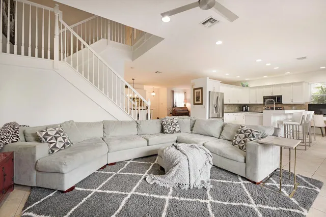 a living room with furniture or kitchen view and a wooden floor