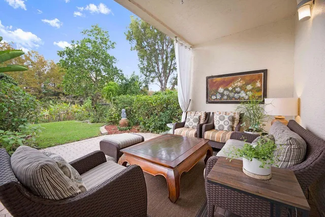 a outdoor living room with furniture and a garden