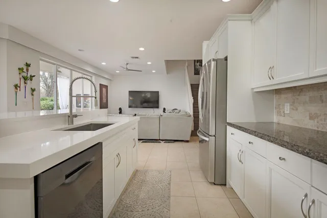 a large kitchen with cabinets and stainless steel appliances