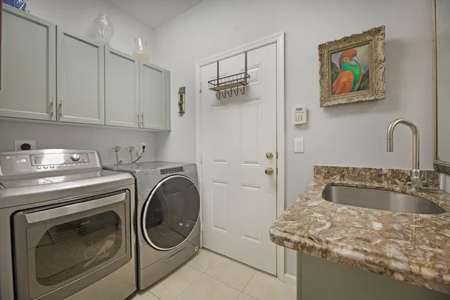 a utility room with sink dryer and washer