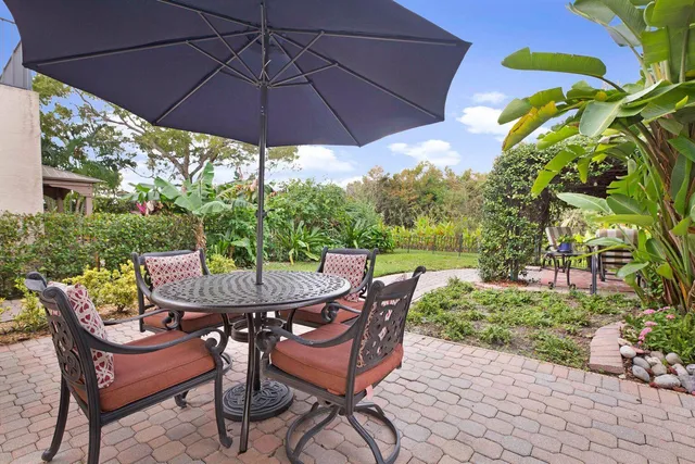 a patio with a patio table and chairs