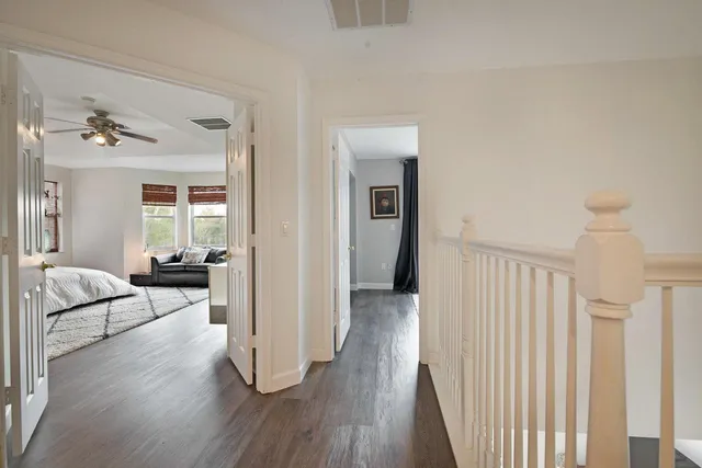 a view of a livingroom with wooden floor and furniture