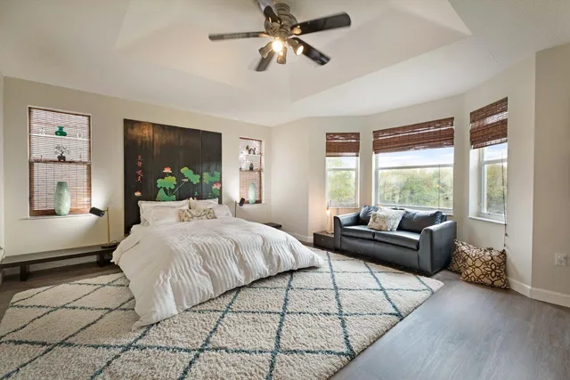 a bedroom with a bed couch and window