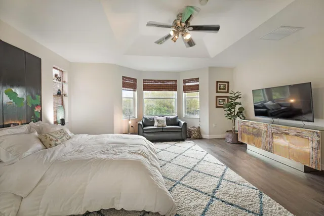 a bedroom with a large bed and a flat screen tv