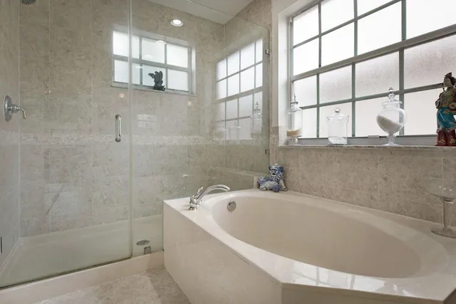 a white bath tub sitting next to a window