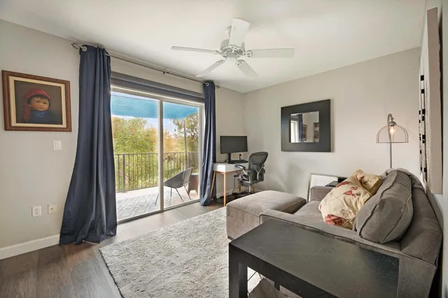 a living room with furniture and a floor to ceiling window