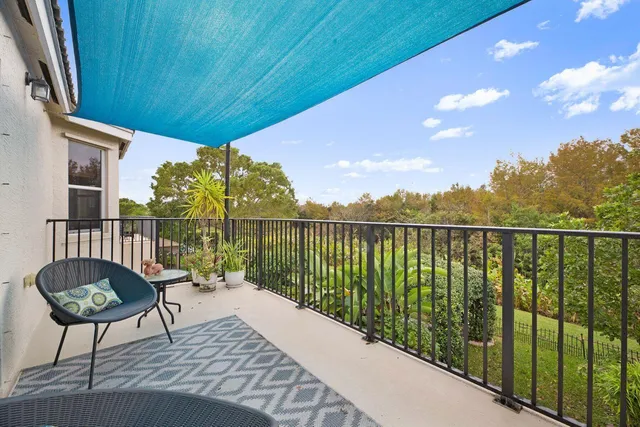a roof deck with table and chairs