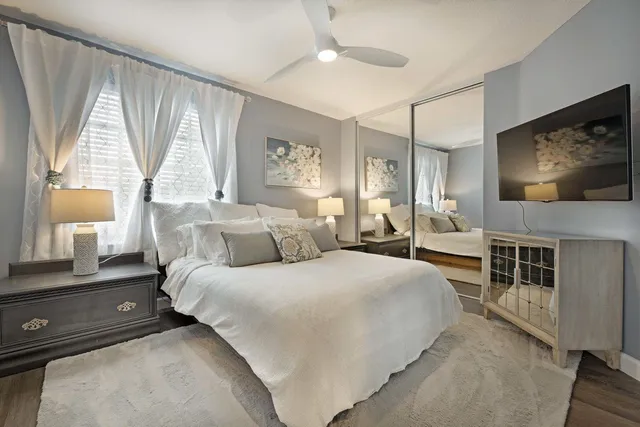 a bedroom with a bed and a flat screen tv