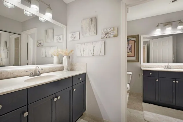a bathroom with a double vanity sink and a mirror