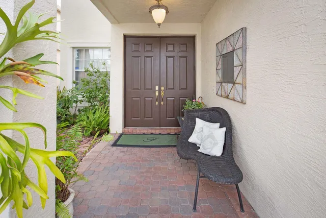 a living room with a couch and potted plant
