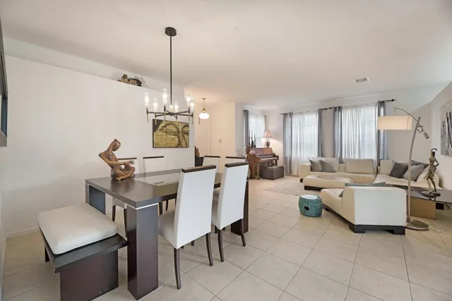 a living room with furniture a rug and white walls