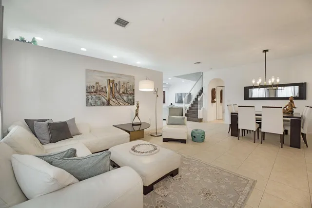 a living room with furniture and a lamp