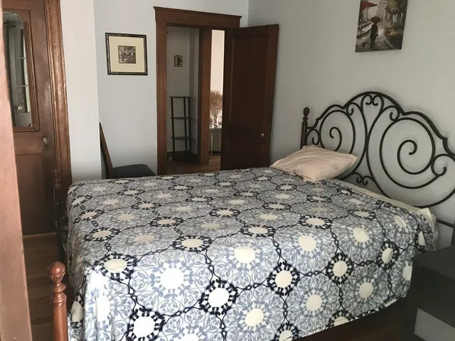 a bedroom with a bed and a mirror