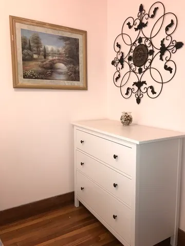 a view of a door with a picture on the wall