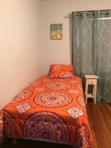 a large bed sitting in a bedroom next to a bathroom