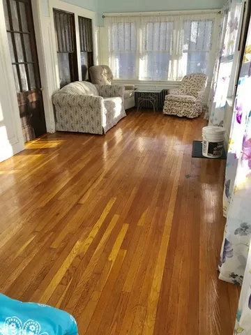 a living room with a bed furniture and a window