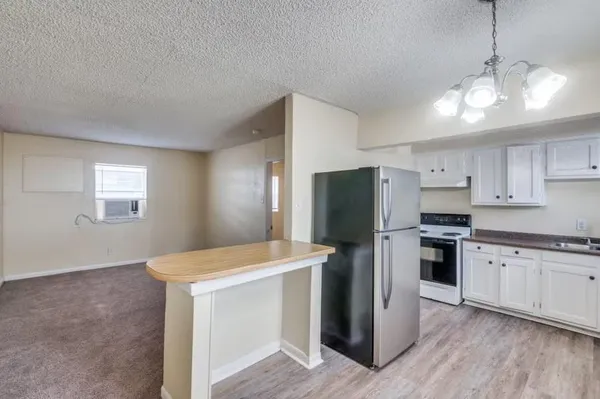 a kitchen with stainless steel appliances a refrigerator sink and microwave