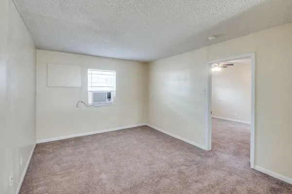 an empty room with windows and closet