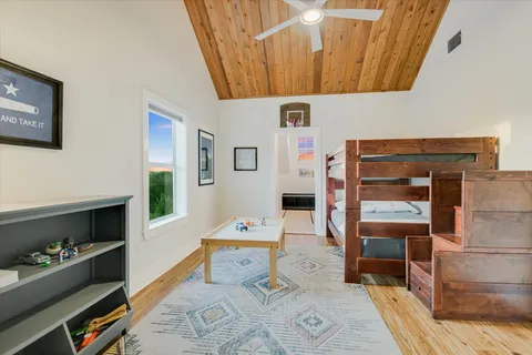 a bedroom with furniture and a baby crib