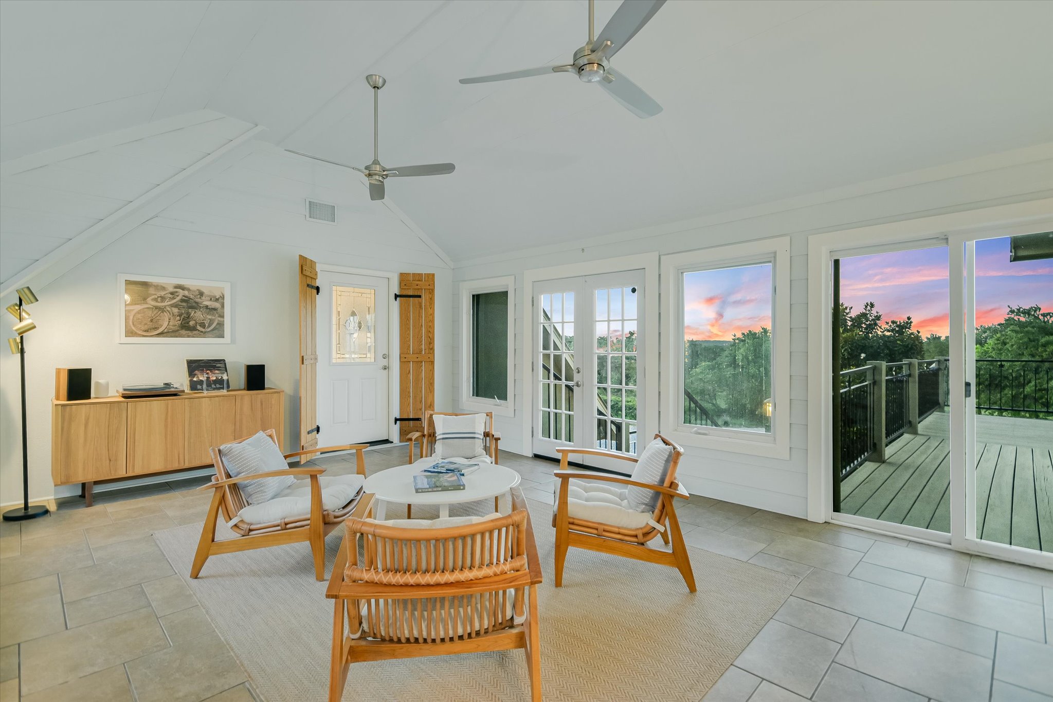 250 Hidden Oaks Road Wimberley, TX 78676 - Photo 17 of 40 a living room with patio furniture and a floor to ceiling window