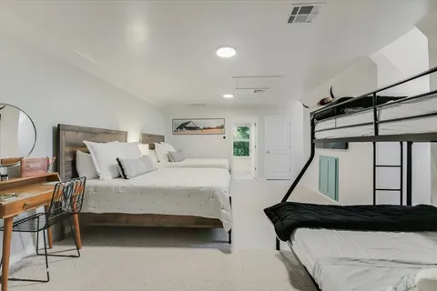 a bathroom with a granite countertop sink a mirror and a bathtub