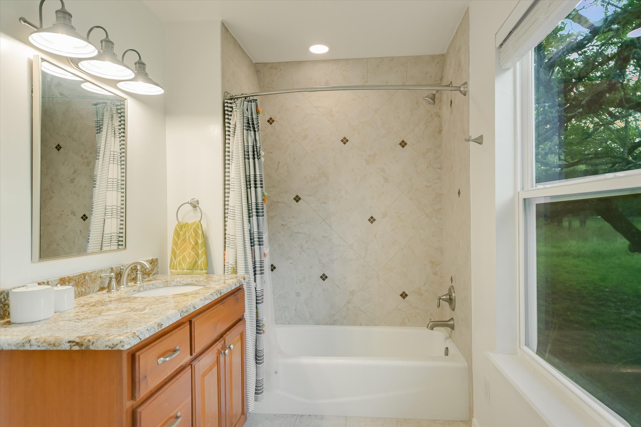 250 Hidden Oaks Road Wimberley, TX 78676 - Photo 19 of 40 a bathroom with a granite countertop sink a mirror and a bathtub