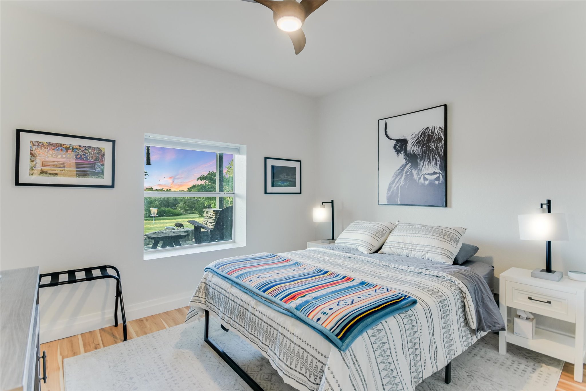 250 Hidden Oaks Road Wimberley, TX 78676 - Photo 20 of 40 a bedroom with a bed and a painting on the wall