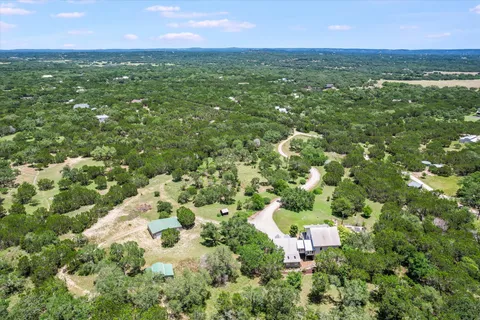 a view of a city with lush green forest