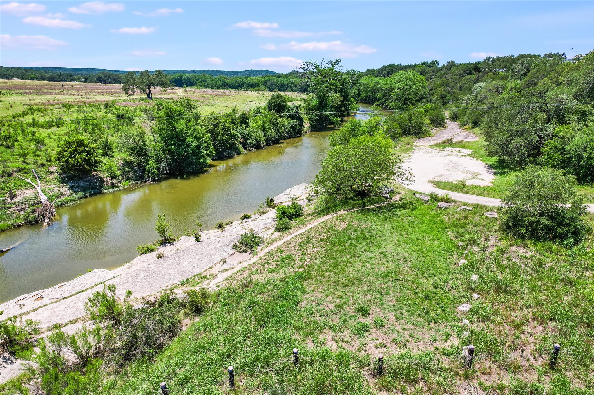 250 Hidden Oaks Road Wimberley, TX 78676 - Photo 38 of 40 a view of a lake with a yard