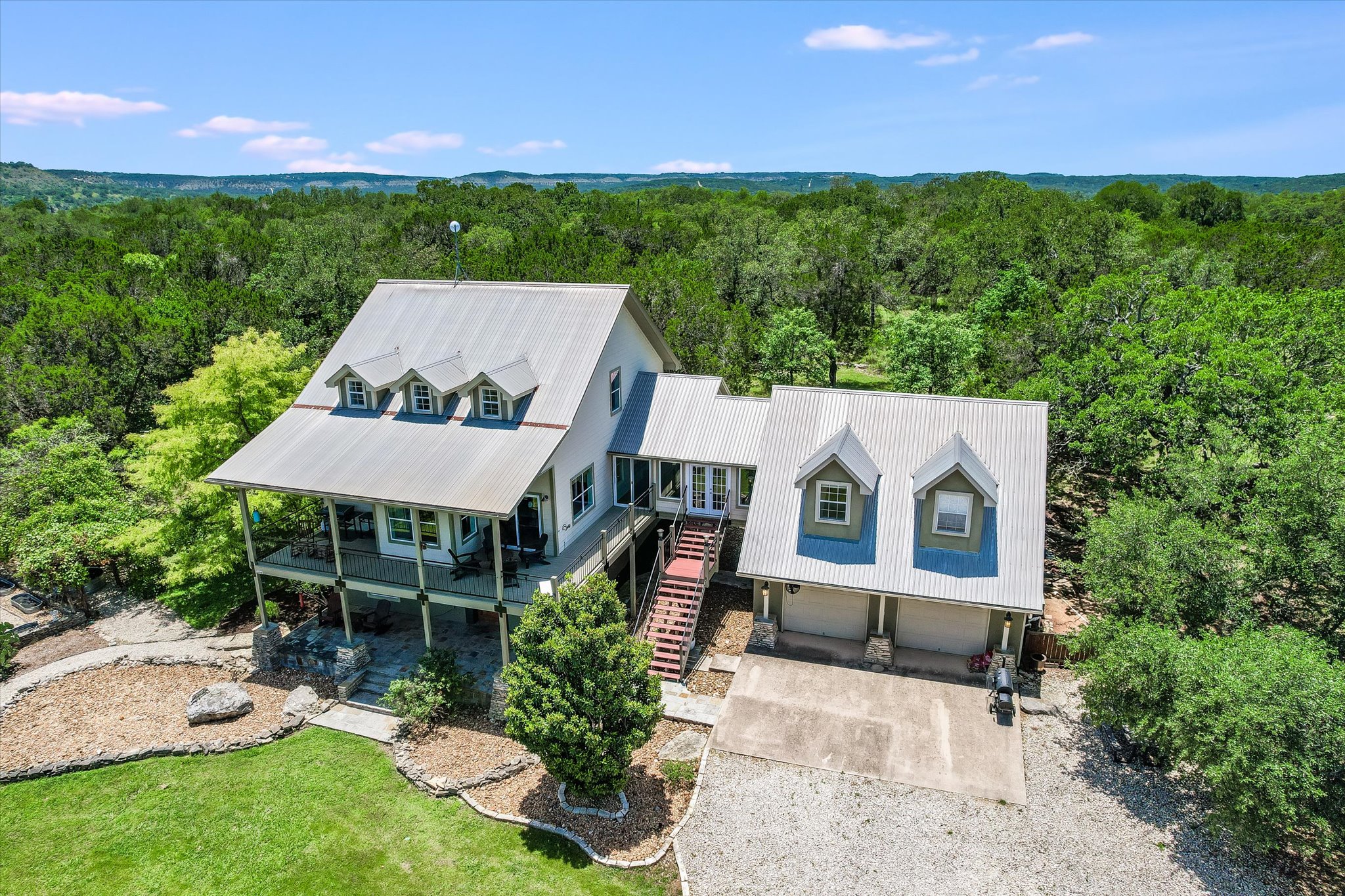 250 Hidden Oaks Road Wimberley, TX 78676 - Photo 40 of 40 a front view of a house with a yard and balcony