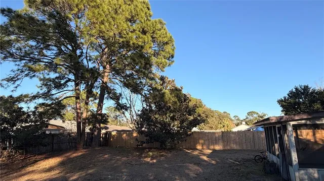 a view of a house with a backyard