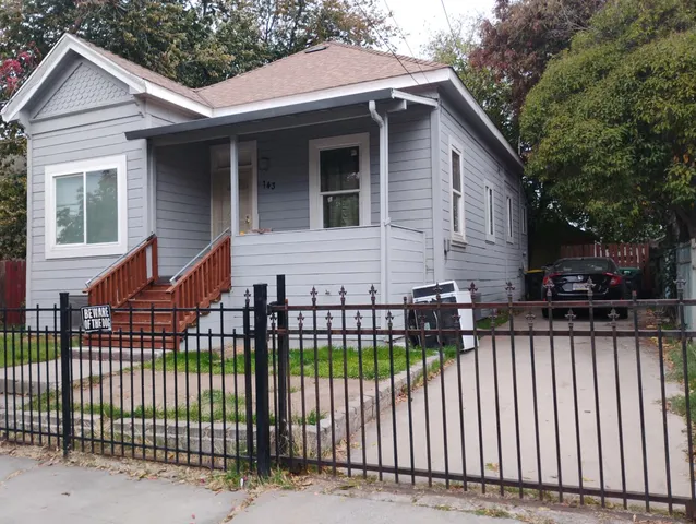 a front view of a house with a garden