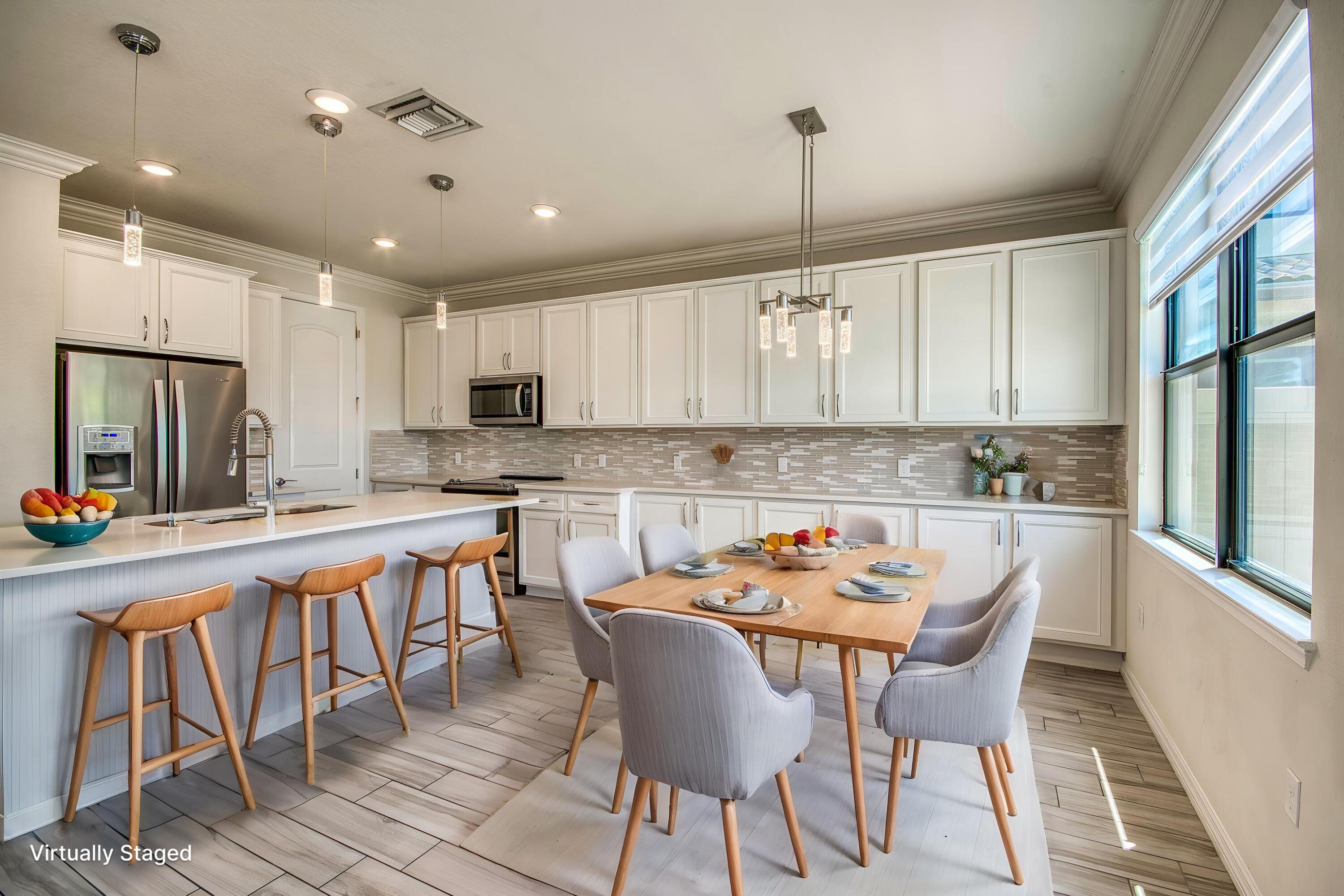 8301 Rearing Lane Lake Worth, FL 33467 - Photo 15 of 33 a view of a dining room with furniture a kitchen and chandelier