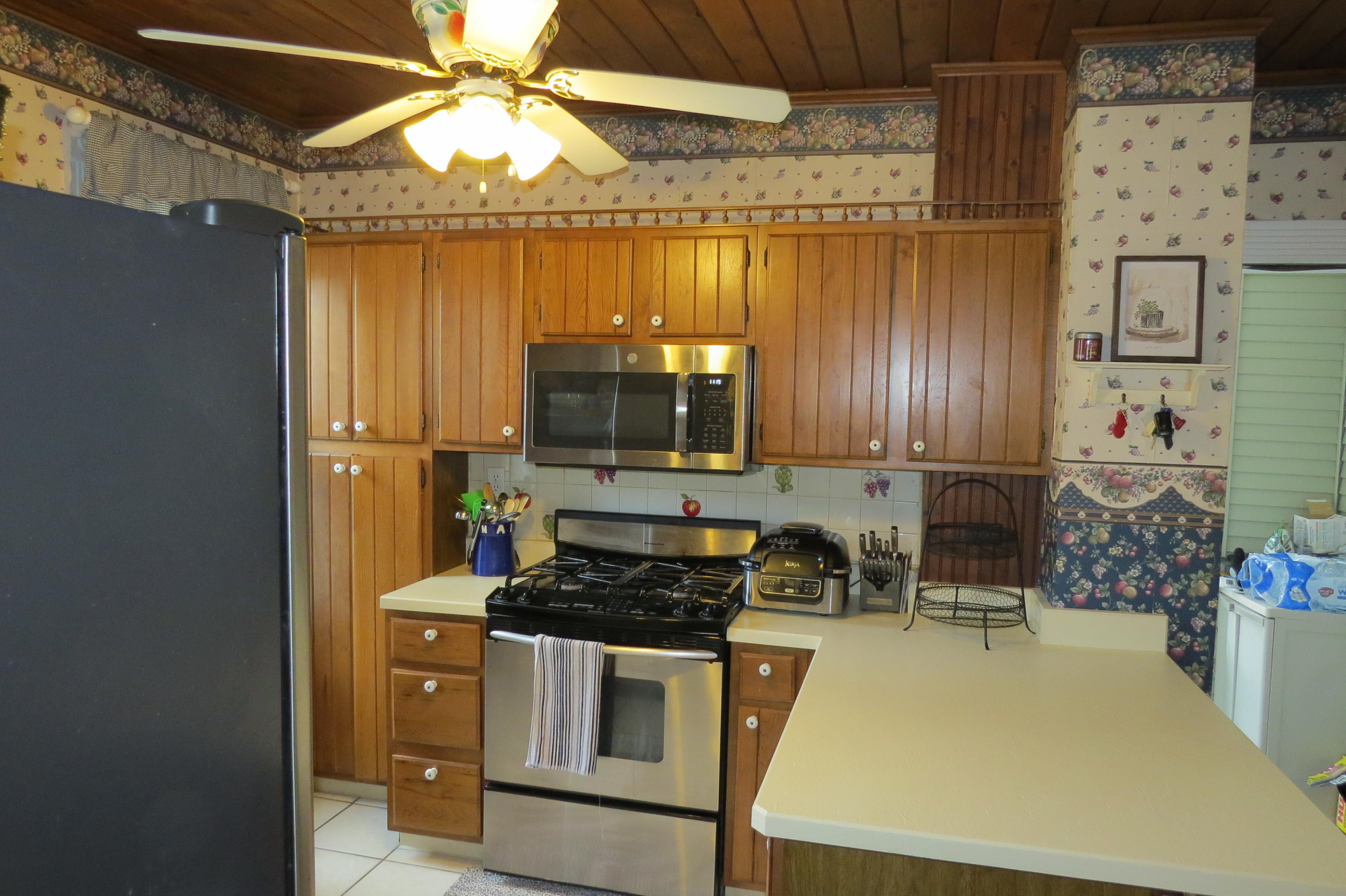 29 Crandall Street Adams, MA 01220 - Photo 23 of 61 a kitchen with stainless steel appliances a stove a microwave a refrigerator and cabinets