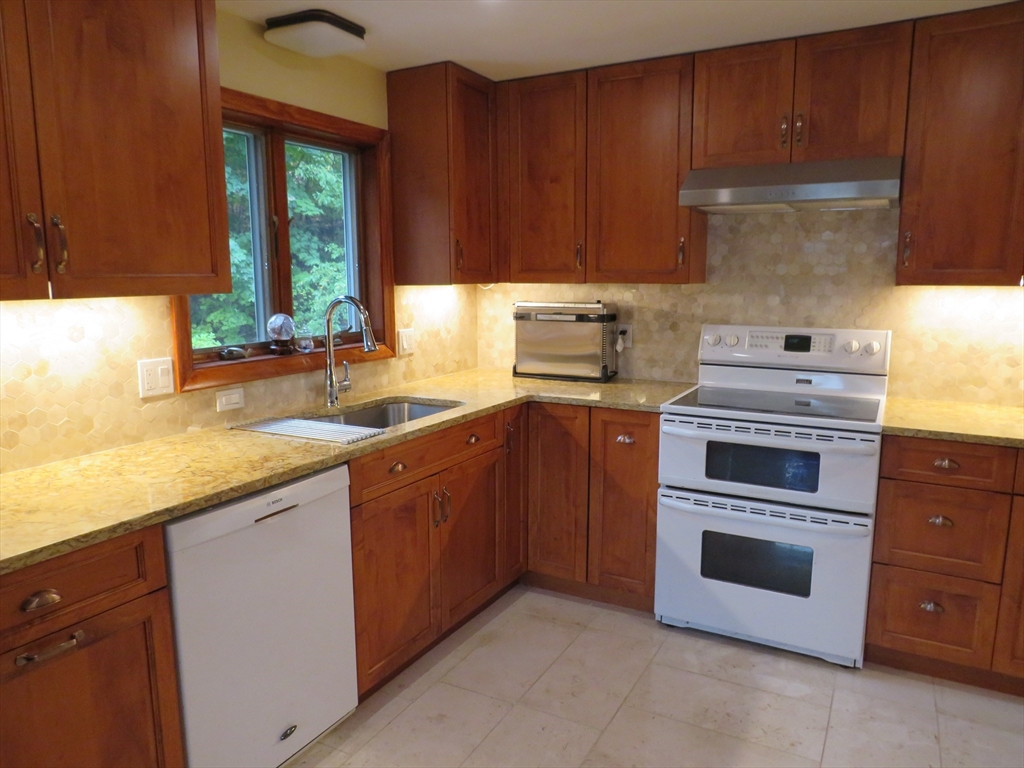 8 Talbot Road Canton, MA 02021 - Photo 11 of 41 a kitchen with granite countertop wooden cabinets and a sink