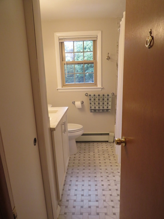 8 Talbot Road Canton, MA 02021 - Photo 13 of 41 a bathroom with a sink a toilet a window and vanity