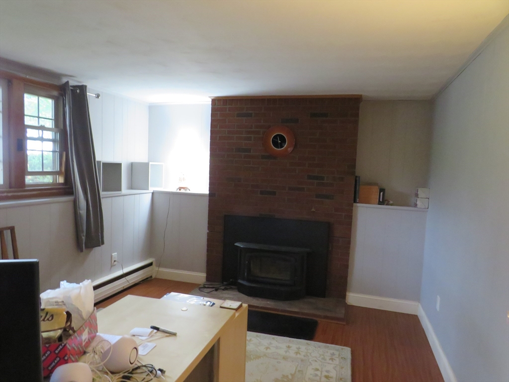 8 Talbot Road Canton, MA 02021 - Photo 24 of 41 a living room with a fireplace furniture and a flat screen tv