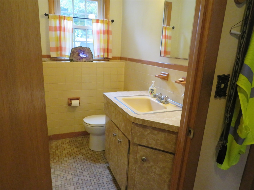 8 Talbot Road Canton, MA 02021 - Photo 26 of 41 a bathroom with a sink and mirror with toilet