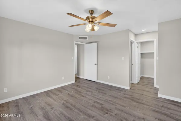 a view of an empty room with wooden floor