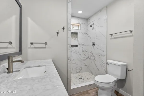 a bathroom with a toilet and a shower