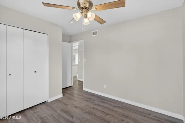 a view of an empty room with wooden floor