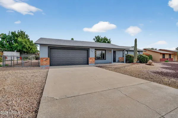 a front view of a house with a yard and a garage