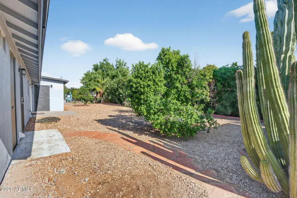 a backyard of a house with a yard and outdoor seating