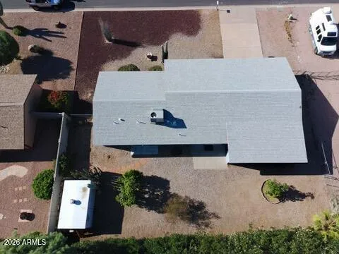 an aerial view of a house with a parking lot