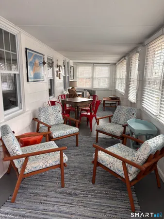 a living room with furniture a rug and a window