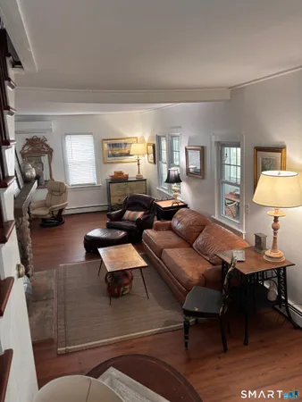 a living room with furniture and a lamp