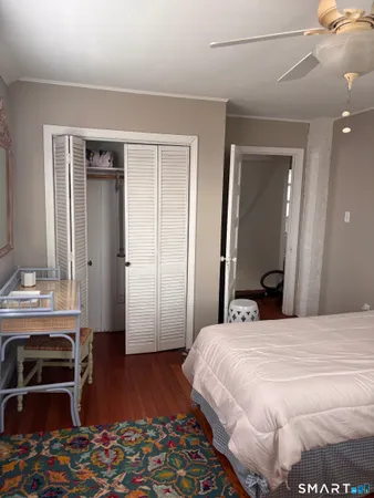 a bedroom with a bed and a dresser in it