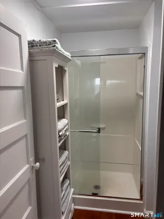 a bathroom with a glass shower door
