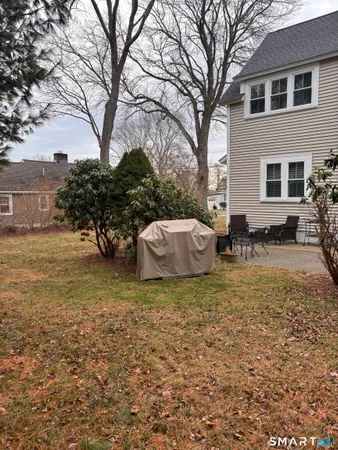 a backyard of a house with table and chairs